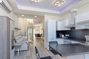 living area on 9th floor with comfortable spiral staircase leading to FULL interconnecting private roof terrace on 10th floor featuring two sun-beds, top of the range BBQ, sink and 6 person table with chairs. Staircase starts from 8th floor below
