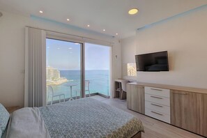 master bedroom - 8th floor w/ ensuite bathroom. AC, queen-size bed w/ underlying storage space, 2 bedside tables, large 6 door wardrobe, dressing table, mirror, chair,  large chest of drawers, 49” flat screen smart TV. leads to private medium balcony