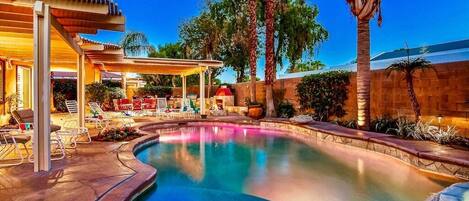 Large pool with a tanning bed and waterfall feature