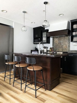 Bright modern kitchen with bar seating. Has all of the cooking accessories you need during your stay.