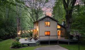 Backyard view w/ decks, grill, fire pit, creek sounds & space to shoot hoops with family or friends