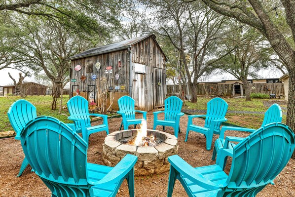 Gather around the firepit with its warmth and flickering flames inviting laughter and stories into the night