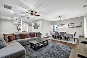 The cozy living room welcomes you to unwind and relax with soft blankets and plenty of comfortable seating