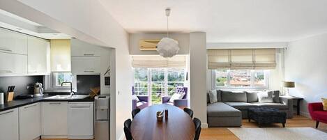 Dining table with open kitchen and living room.