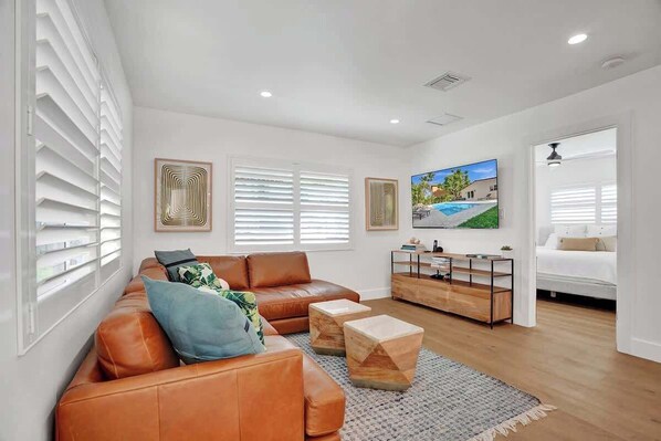Spacious living room with comfortable sectional and large screen HD TV