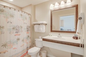 Awesome bathroom with ample counterspace, a large mirror, and a bathtub + shower combo!