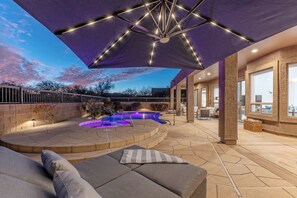 The backyard features resort amenities that include a covered patio with a variety of seating choices, pool with optional heat, built-in spa and propane grill.