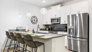 Compact kitchen with a quaint mini breakfast bar for cozy and convenient dining