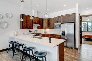 Stunning Kitchen With Large Island And Bar Seating For 4 People