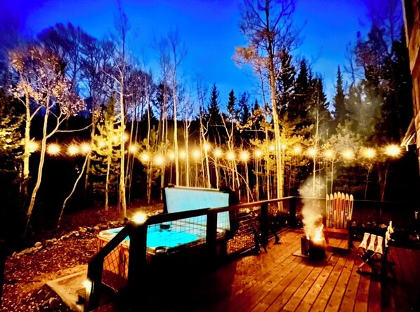 Large deck with hot tub, seating, solo stove and ring game.  Space for yoga mats