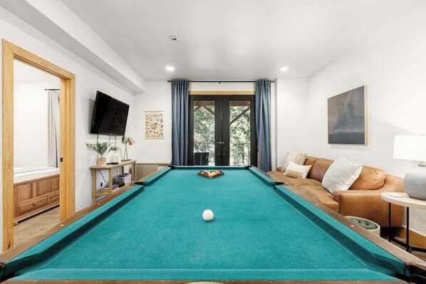 Game room doors lead to the backyard and trails