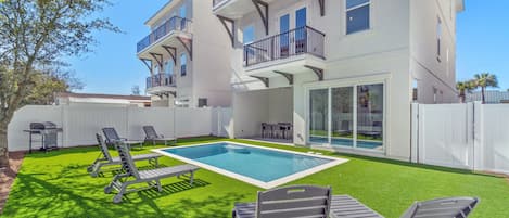 Spacious pool area with artificial turf