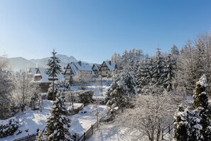A stunning winter landscape of snowy trees and rooftops.
