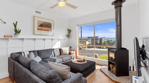 The living room looks inviting with its comfy couches, flat-screen TV, and Wi-Fi. 