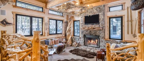 Cosy living area with a fireplace and amazing woodsman design.