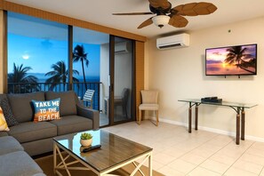 A serene blend of sunset art, cushy seating, and warm tones welcomes you to your slice of paradise VIR-508