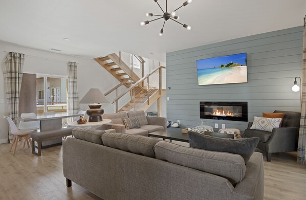 Living room offers plenty of seating around an electric fireplace and ROKU TV