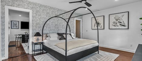 The beautiful curved canopy bed in the spacious bedroom