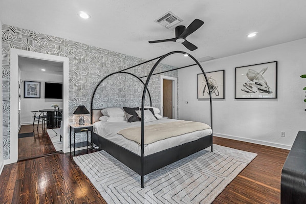 The beautiful curved canopy bed in the spacious bedroom