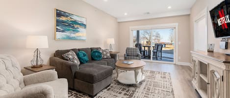 A living area seamlessly connected to a charming patio with walk-out to town and the beach.