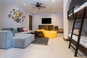 Living room with TV, couch and bunk bed