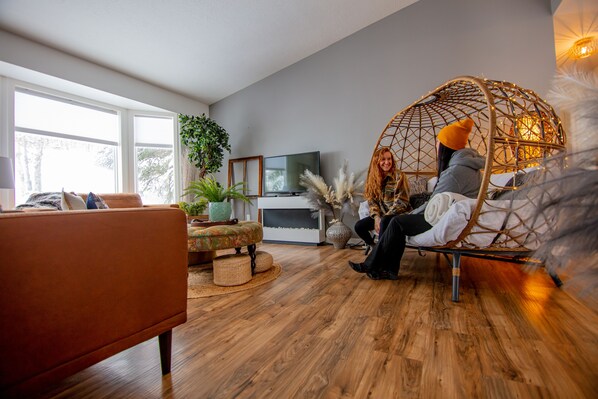 Enjoying the living room in the wicker chair 