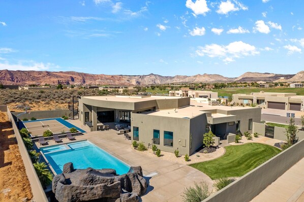 Back View - The Back View highlights the private pool, hot tub, basketball court, and grilling area, as well as the beautiful mountains surrounding our home.