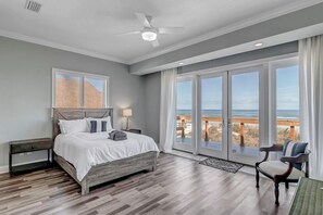 Ocean Bedroom #2 - - Wake up to pristine ocean views in this queen bedroom with sliding glass doors, beachy tones, and a modern bed
- Thoughtful touches like a reading chair and nightstand create a restful retreat
- Enjoy a private entrance to the scenic outdoor space