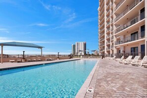Indulge in the refreshing shared pool area, where you can relax by the shimmering poolside oasis and bask in sun-kissed luxury near the water. Enjoy the sleek pool deck design for a touch of modern elegance.