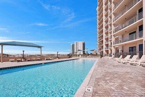 Indulge in the refreshing shared pool area, where you can relax by the shimmering poolside oasis and bask in sun-kissed luxury near the water. Enjoy the sleek pool deck design for a touch of modern elegance.