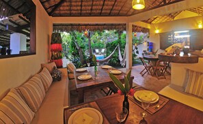 Lounge area can seat 12-13 people with pool and garden views.
