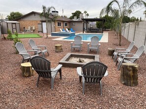 Fire pit in back yard and view of big back yard