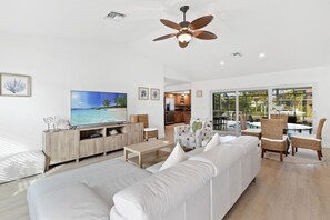 Unwind in a Chic Space with a Brand-New Sofa and Thoughtfully Selected Furniture, Offering Picturesque Views of the Pool and Scenic Canal.