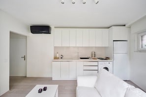 Bright open fully equipped kitchen with an A/C unit:)