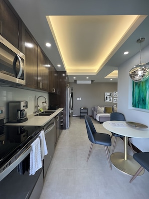 Kitchen area with a table and 3 chairs.
