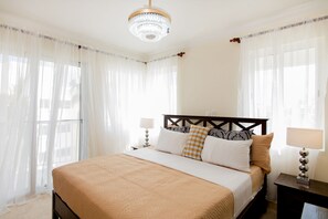 En-suite bedroom has King's size bed, large closet, balcony and garden view. 