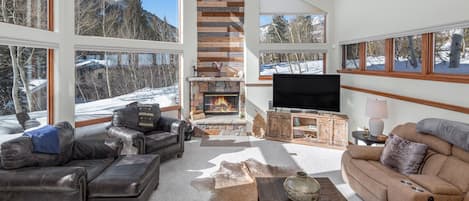 Living Room with Large Windows with Views, TV, and Fireplace