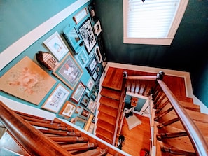 A view from a top the beautiful & historic two-story staircase.