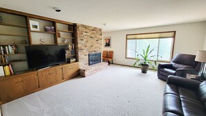 Spacious living room with power recliners and fireplace.