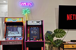 Arcades in the living room next to large smart TV 
