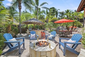 A fire pit, outdoor kitchen & heated pool quickly get you in vacation mode