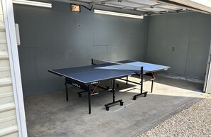 Back of garage opens up toward house with covered ping-pong / game room