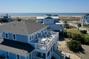 Relax on the large front deck with table, chairs and chaise lounges and view the ocean, have a meal or read a good book