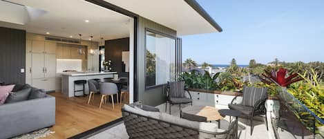 Oversized balcony with table and chairs up the opposite end