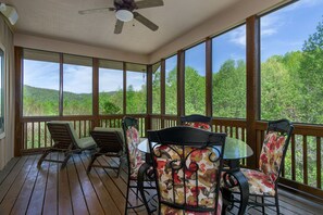 Dine al fresco with a scenic mountain backdrop on the screened porch.