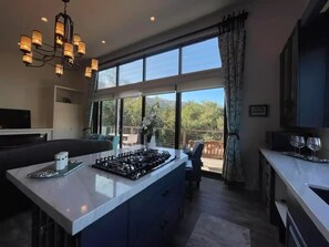 Full size fully stocked kitchen with private balcony with outdoor seating.