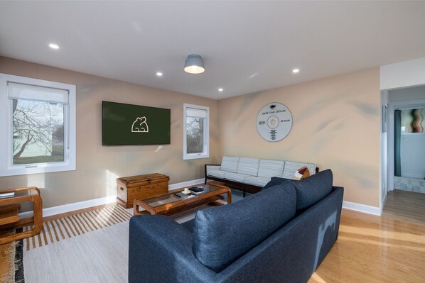 Living room with grey sofa bed. 