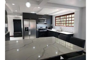 Laundry room, pantry and a country bench complement this kitchen. 