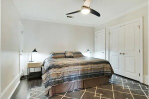 Spacious bedroom with a comfortable king-size bed and modern decor.