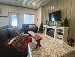 Living room with Roku TV and electric fireplace